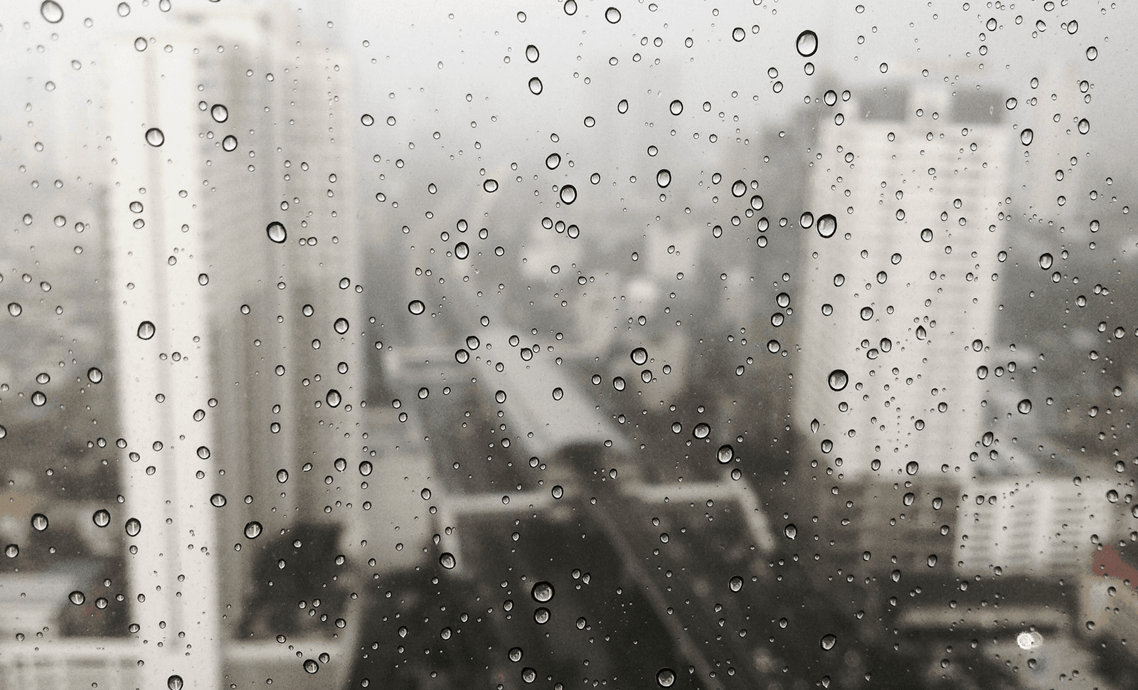 Rain on a high-rise window over the Houston skyline